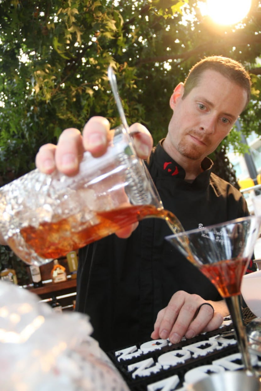 Bartender Bryan Dalton put the finished touches on his signature drink the Johannesburg from...