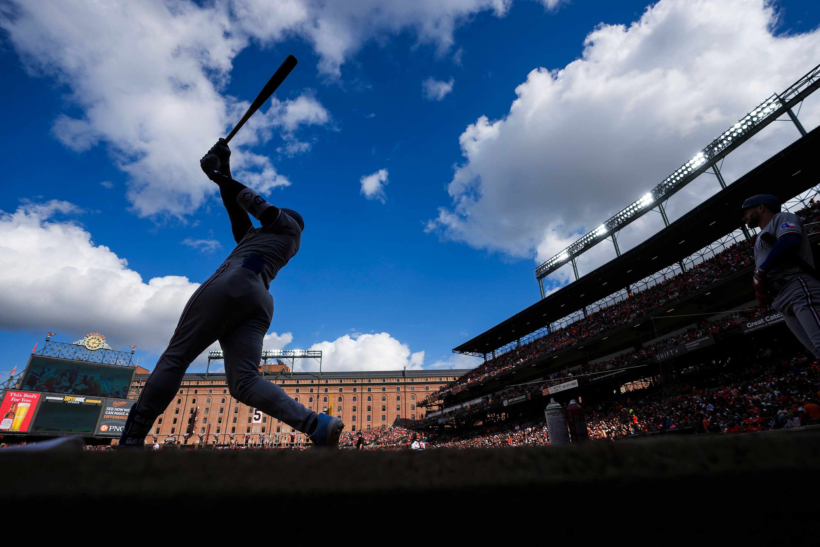 Texas Rangers right fielder Adolis Garcia takes a swing on deck before hitting during the...