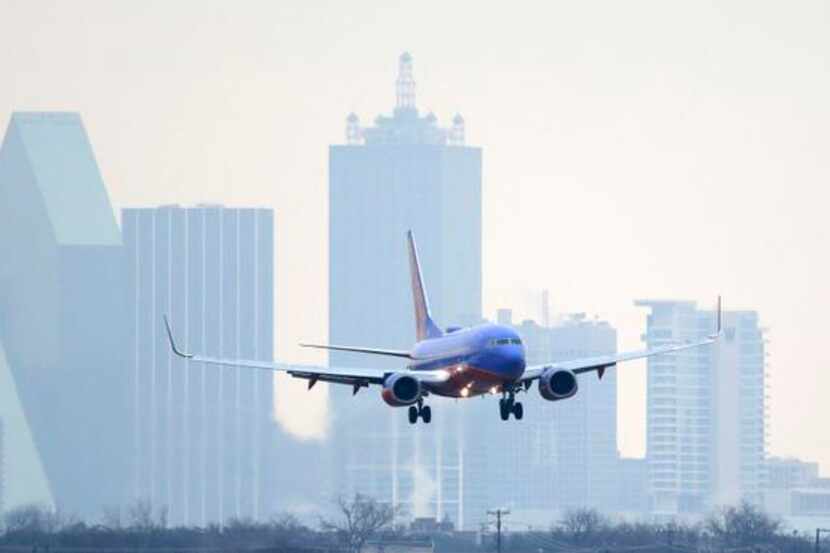 
A Southwest Airlines jet arrives at Dallas Love Field. Southwest is one of three carriers...