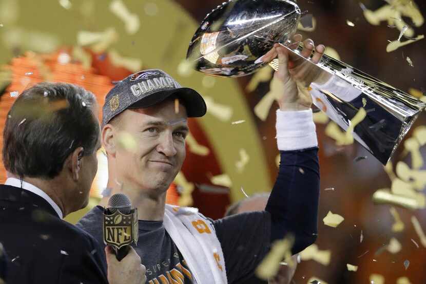 
Peyton Manning holds the Lombardi Trophy after the NFL Super Bowl 50 football game against...