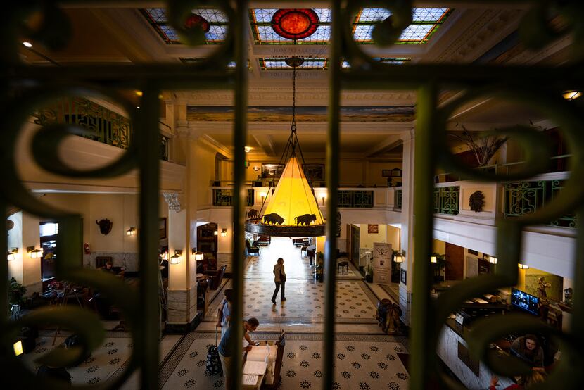 Guests walk through the two-story lobby of the Plains Hotel, the world's first to have...