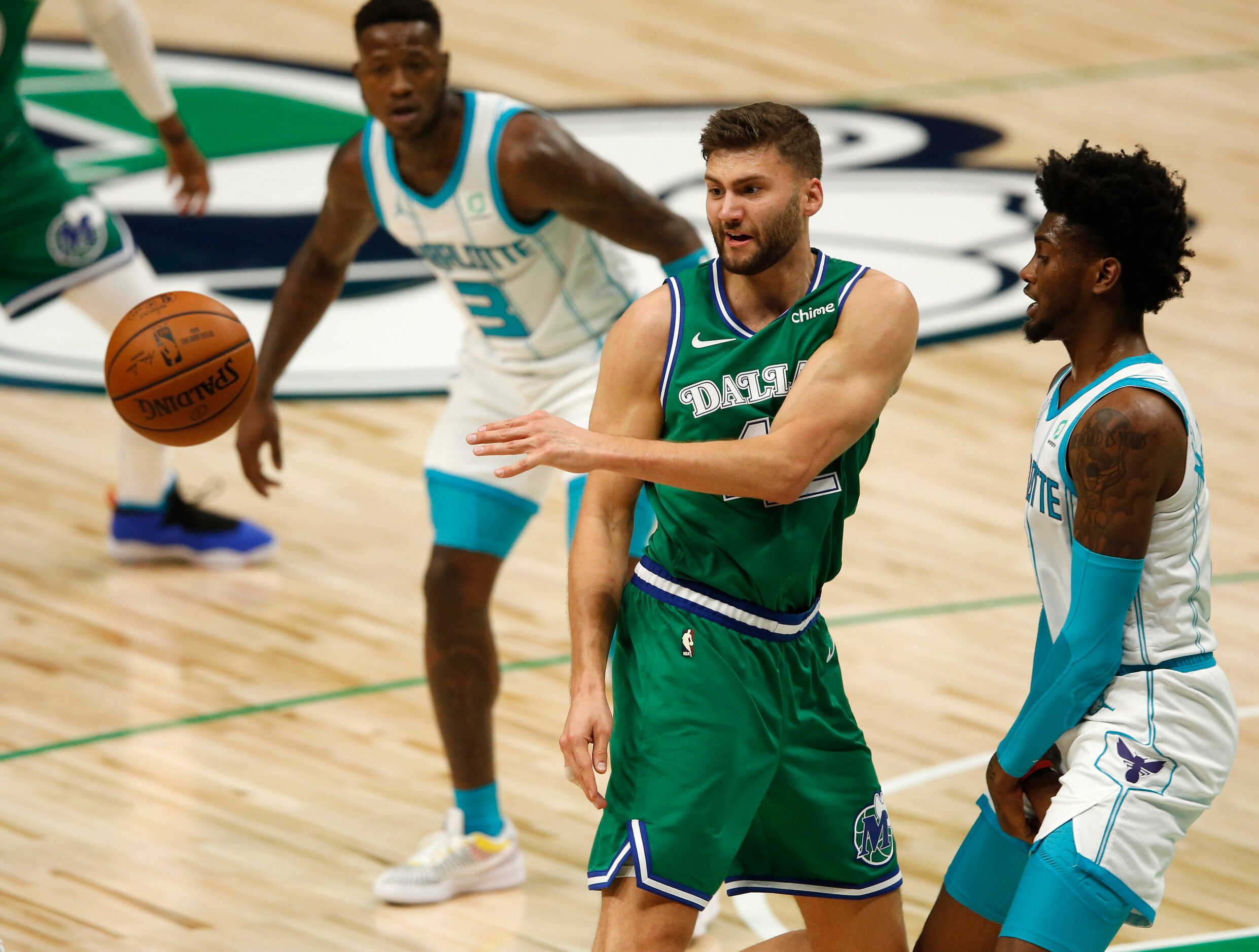 Dallas Mavericks forward Maxi Kleber (42) passes the ball out as Charlotte Hornets forward...