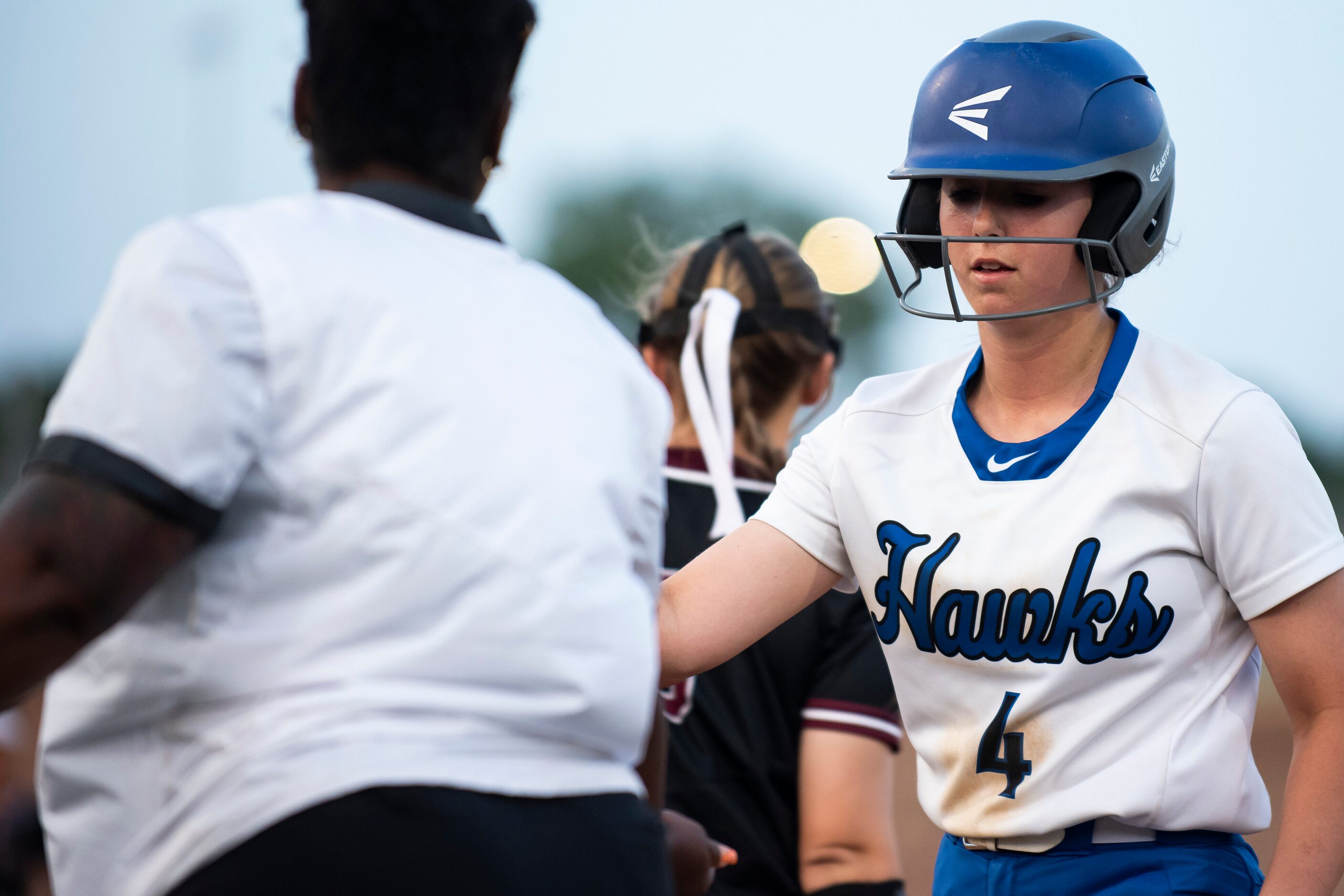 Hebron’s Alyssa Sneed (4) high fives her first base coach after getting a hit during the...