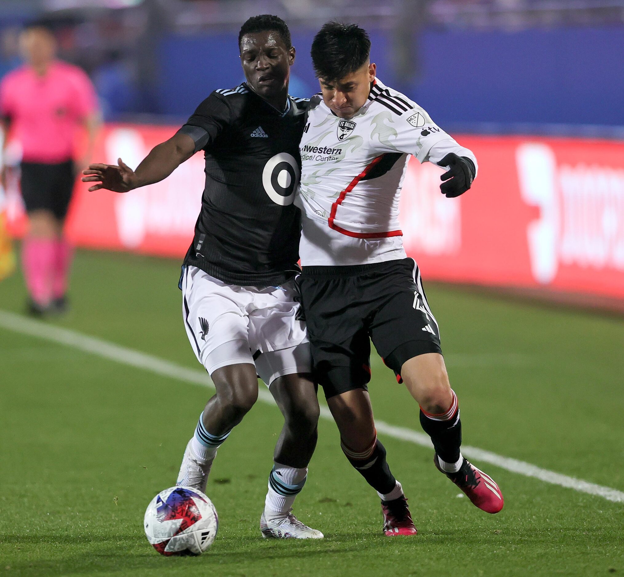 FC Dallas defender Marco Farfan, (right) and Minnesota United attacker Bongokuhle Hlongwane,...