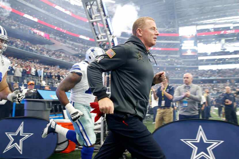 Dallas Cowboys head coach Jason Garrett runs onto the field against Baltimore Ravens AT&T...