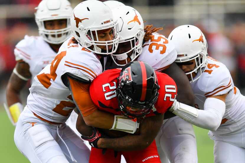LUBBOCK, TX - NOVEMBER 05: Keke Coutee #20 of the Texas Tech Red Raiders is gang tackled by...