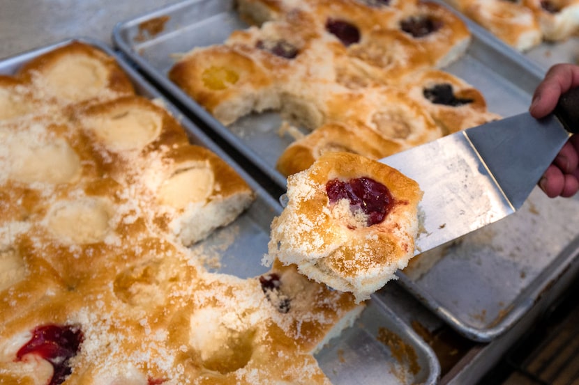 Kasa Kolache bakery co-owner Enrique Barrera prepares a kolache order for customers in...