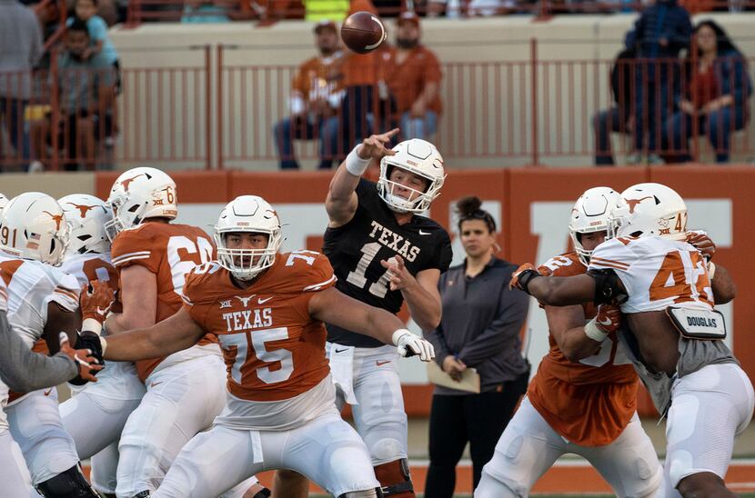 University of Texas quarterback Sam Ehlinger (11) throws a pass that is intercepted...