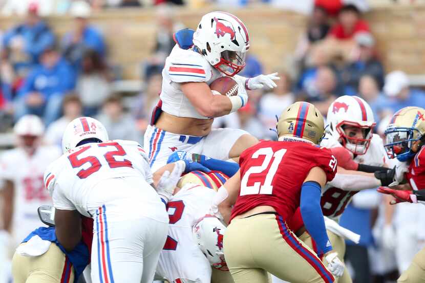 SMU running back Tyler Lavine (31) jumps over a pile while running the ball during the...