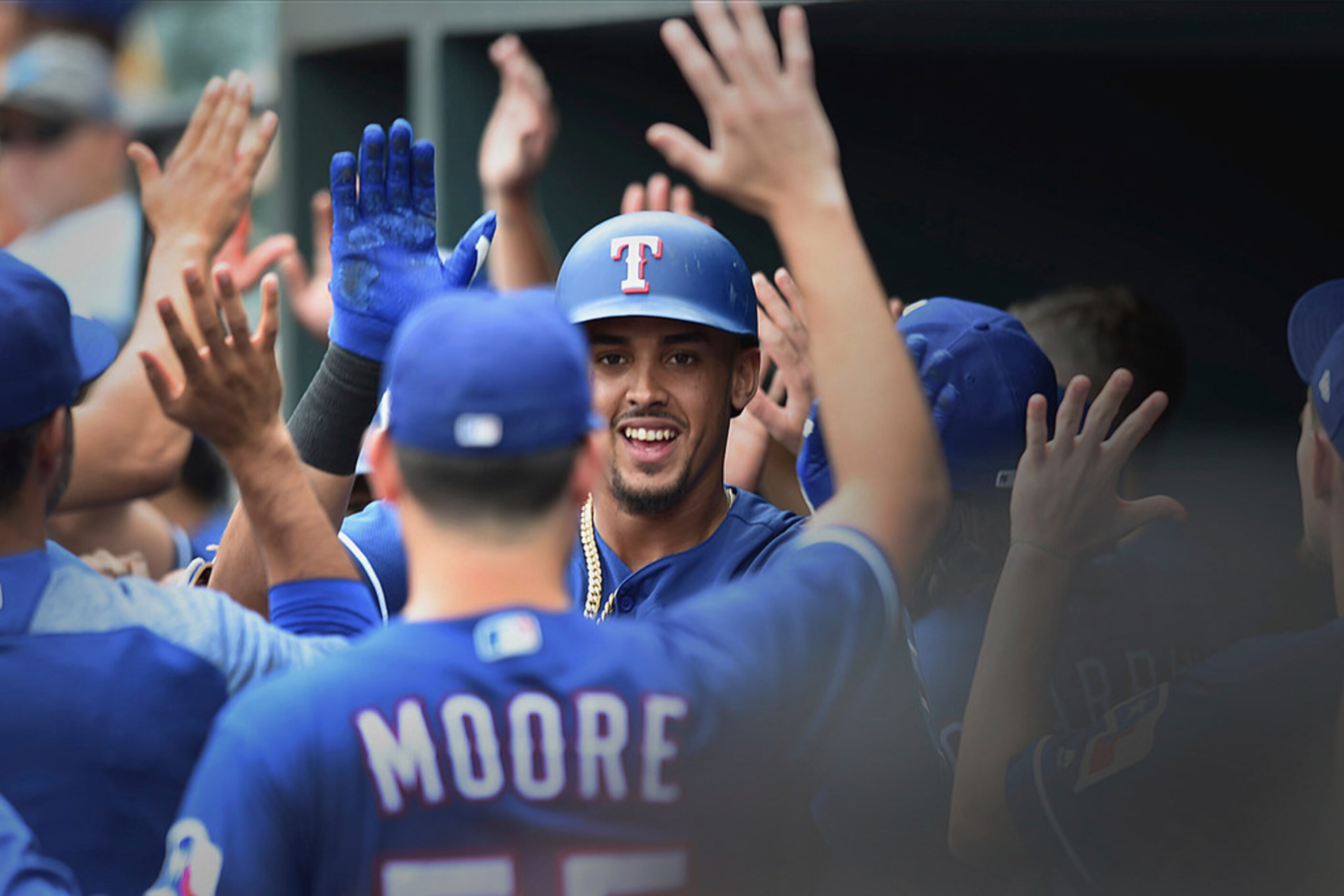 Texas Rangers' Ronald Guzman is congratulated after hitting a grand slam against the...