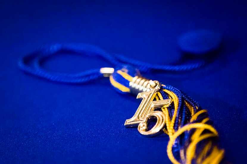 
A mortarboard and tassel bearing a pendant for the year 2015 are displayed backstage before...