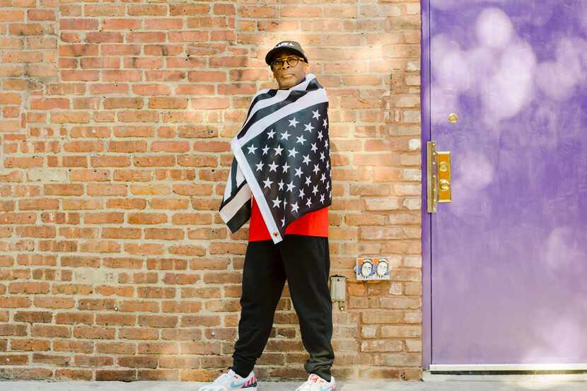Director Spike Lee drapes himself in an upside-down, black-and-white American flag in New...