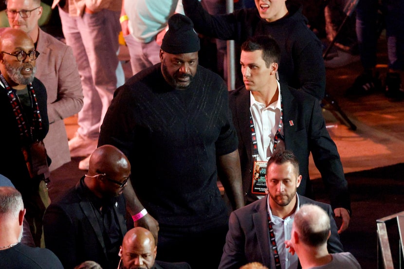 NBA Hall of Famer Shaquille O'Neal makes his way ringside before a heavyweight boxing match...