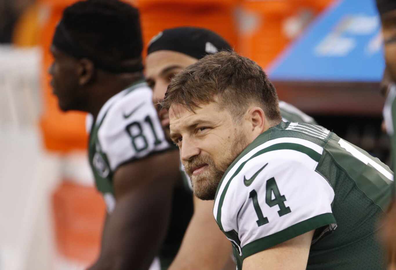New York Jets quarterback Ryan Fitzpatrick (14) watches the game with teammates during the...
