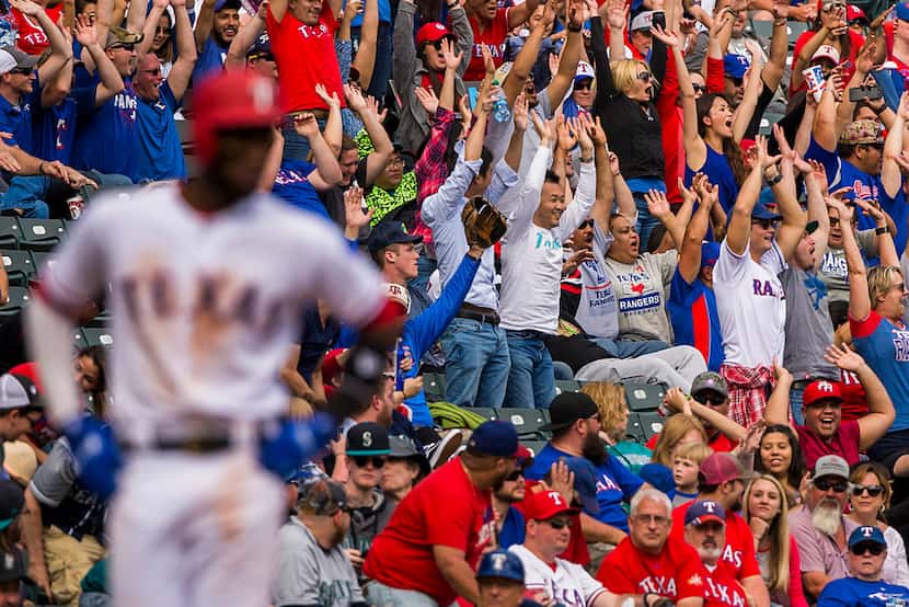 Fans do the wave as Texas Rangers shortstop Jurickson Profar takes a lead off of third base...