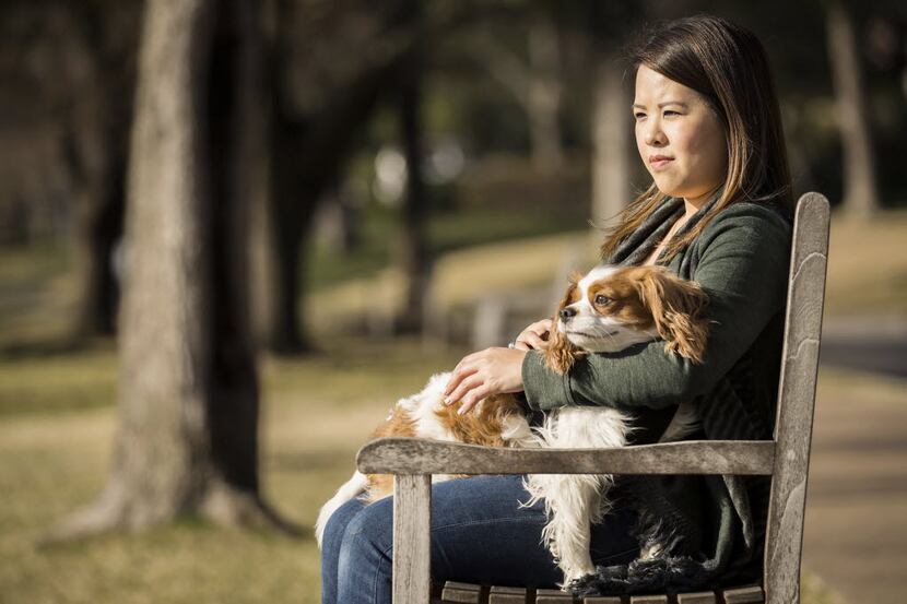 Ebola survivor Nina Pham sits in a park with her dog Bentley on Wednesday, Feb. 25, 2015, in...