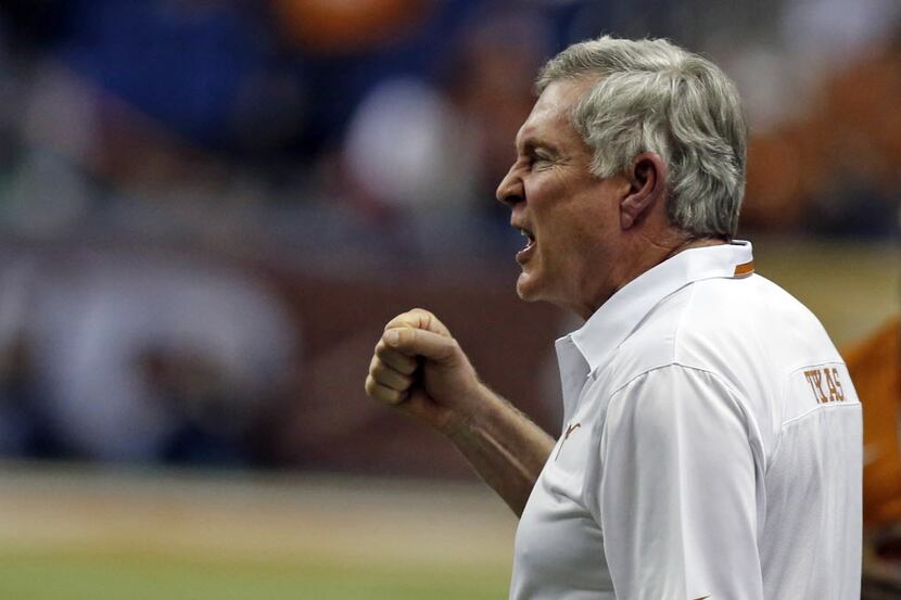 Texas Longhorns head coach Mack Brown cheers his defense as they played the Oregon Ducks...