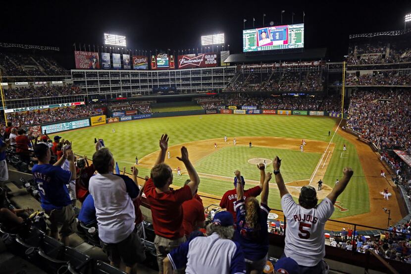 Texas Rangers fan celebrate a two-run homer by Texas Rangers designated hitter Adrian Beltre...