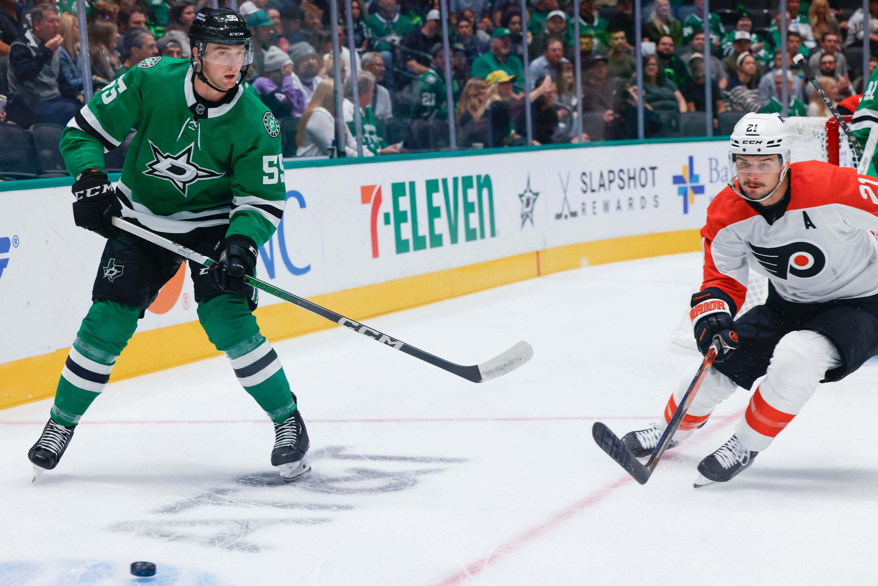 Dallas Stars defenseman Thomas Harley (left) handles the puck against Philadelphia Flyers...