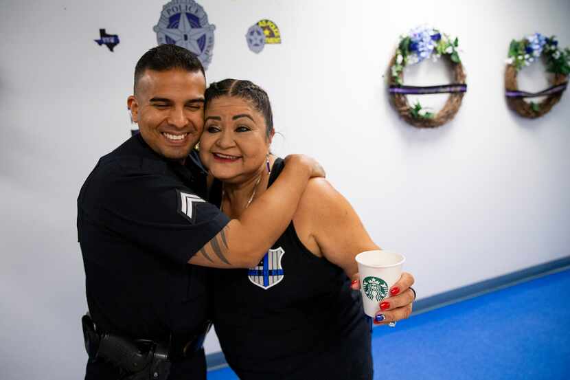 Valerie Zamarripa hugs Sr. Corporal Ruben Lozano on Friday, July 2, 2021, at the Dallas...