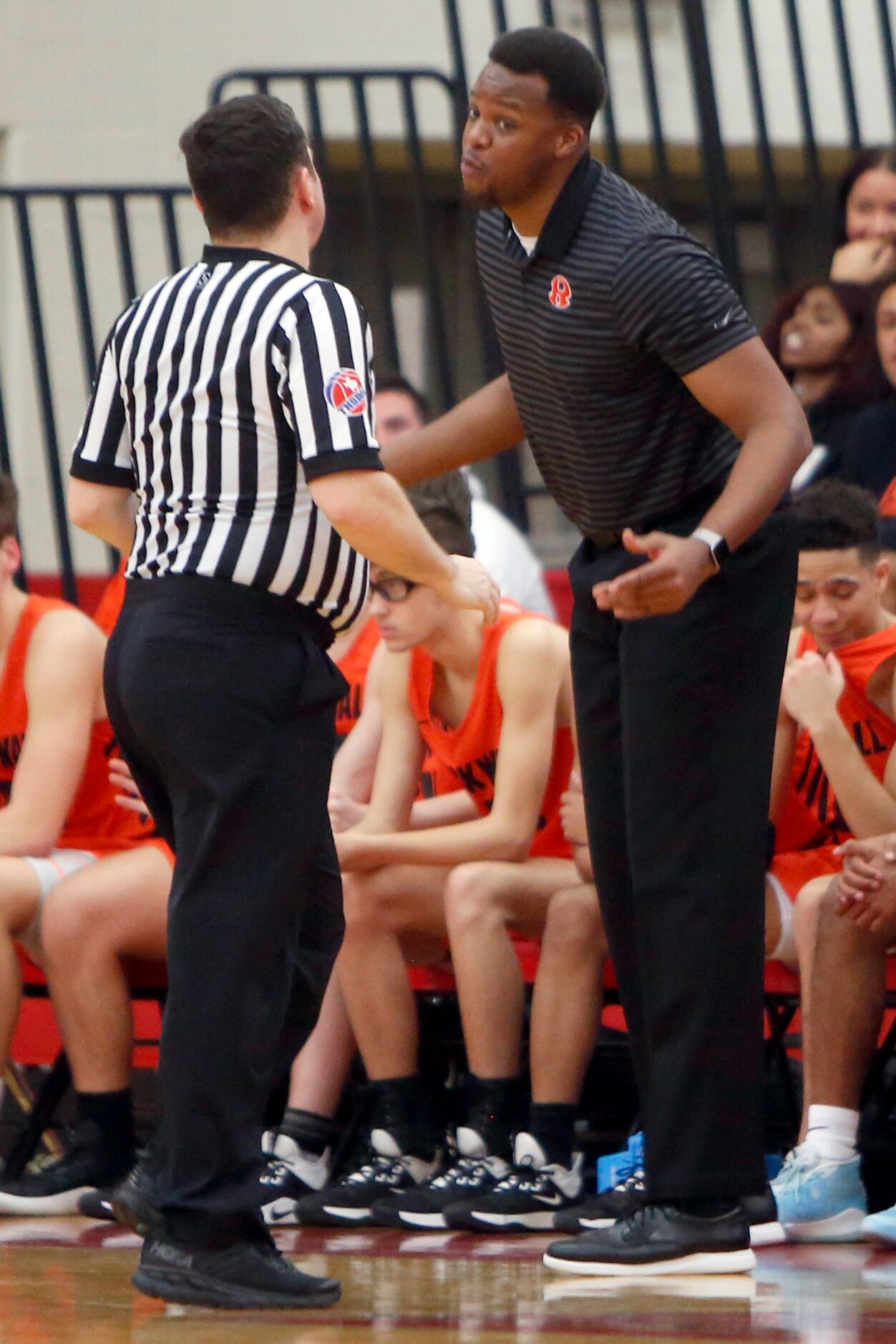 Rockwall head coach Quincy Williams questions a game official following the lack of a call...