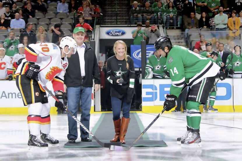 Julie Dobbs  (center) travels with the Dallas Stars as part of her busy schedule with the team