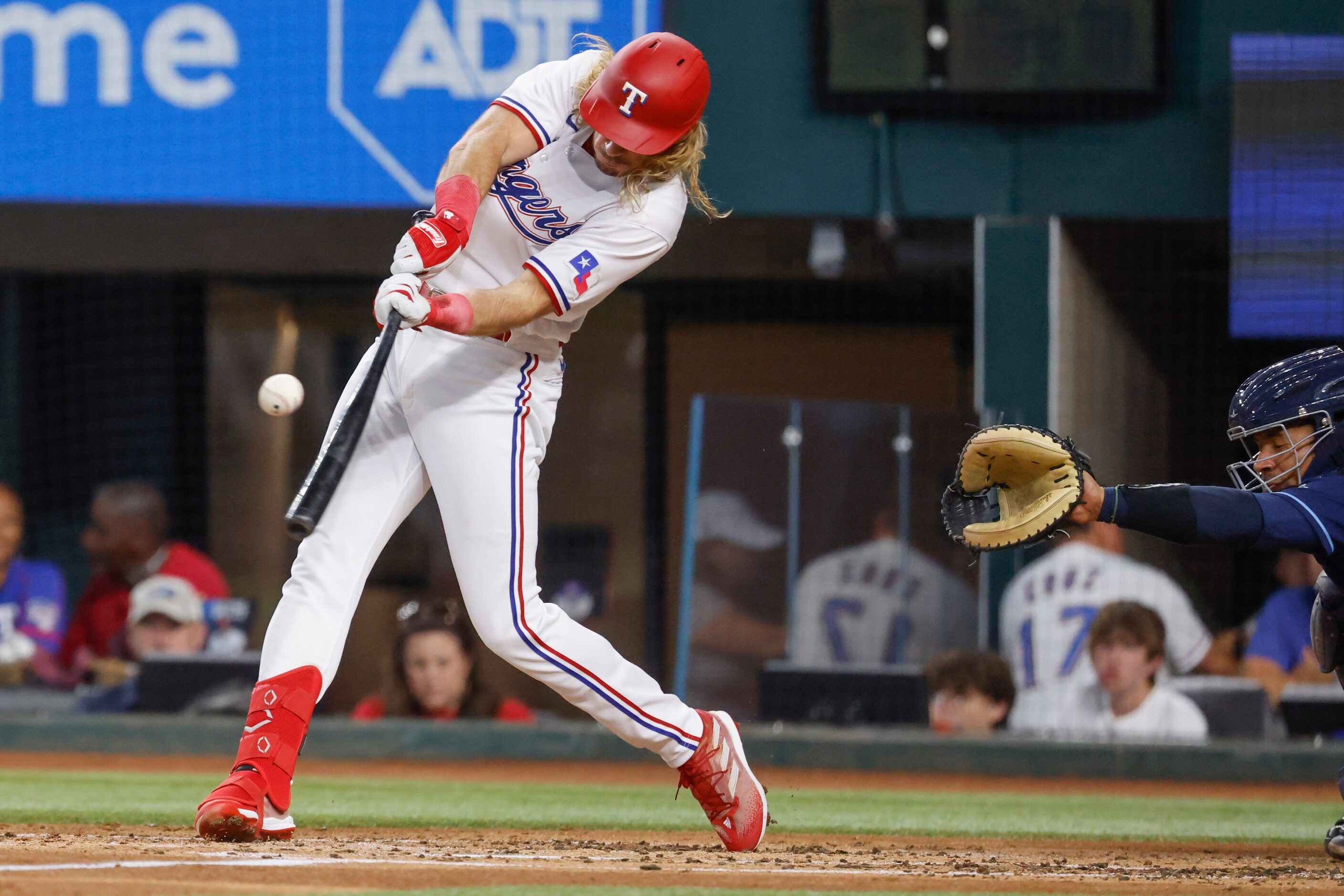 Texas Rangers left fielder Travis Jankowski hits singles on a ground ball during the second...