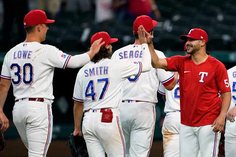 Texas Rangers' Nathaniel Lowe (30). Josh Smith (47), Corey Seager and starting pitcher...