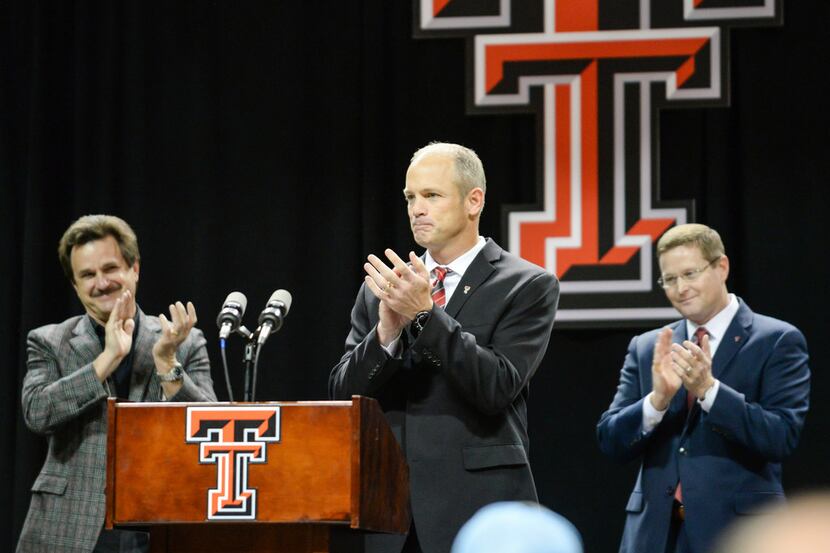 Texas Tech's new head football coach Matt Wells, center receives a standing ovation from...