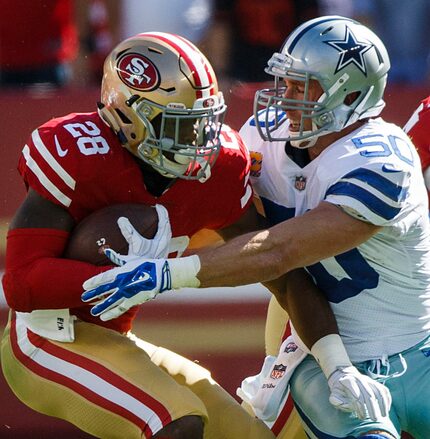 Dallas Cowboys middle linebacker Sean Lee (50) wraps up San Francisco 49ers running back...