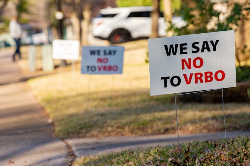 More than two dozen "We say no to VRBO" signs line the blocks surrounding a property in...