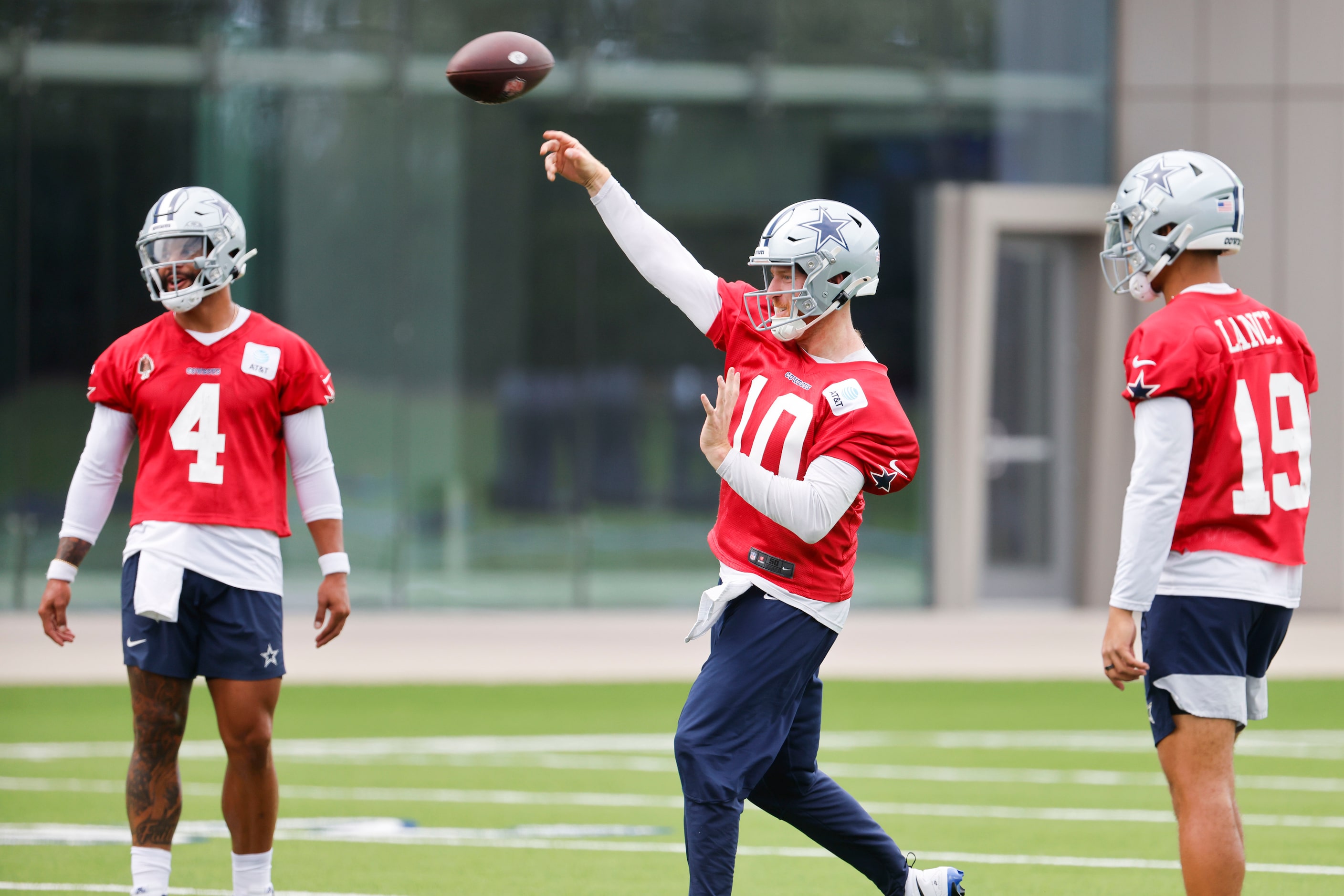 Dallas Cowboys quarterback Cooper Rush (10) throws the ball as other quarterbacks Dak...