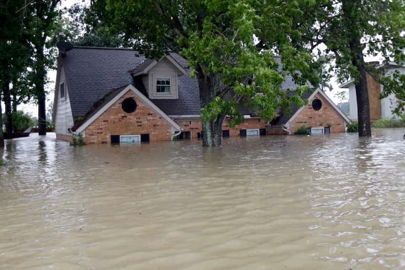 This home was surrounded by floodwaters from Harvey on Monday in Spring.(David J....