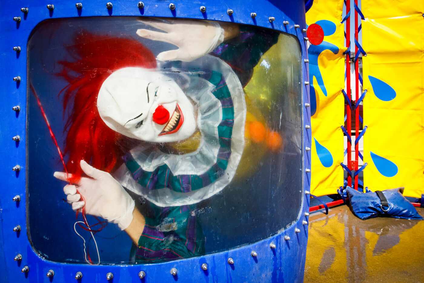 Wearing a clown costume, Cornea Associates Dr. Tyrone McCall peers out from under the water...