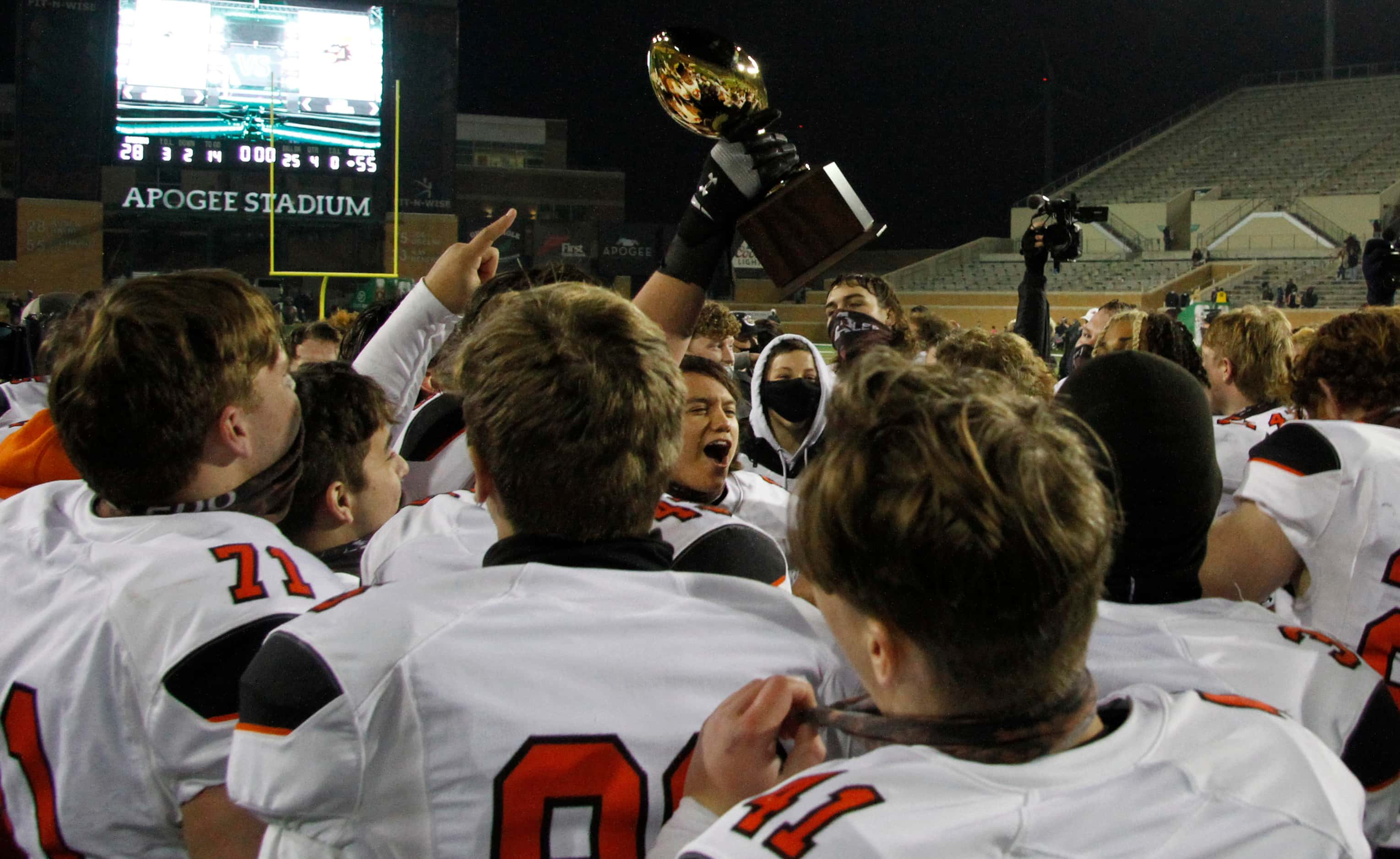 Aledo Bearcats players celebrate with the Class 5A Division ll championship trophy presented...