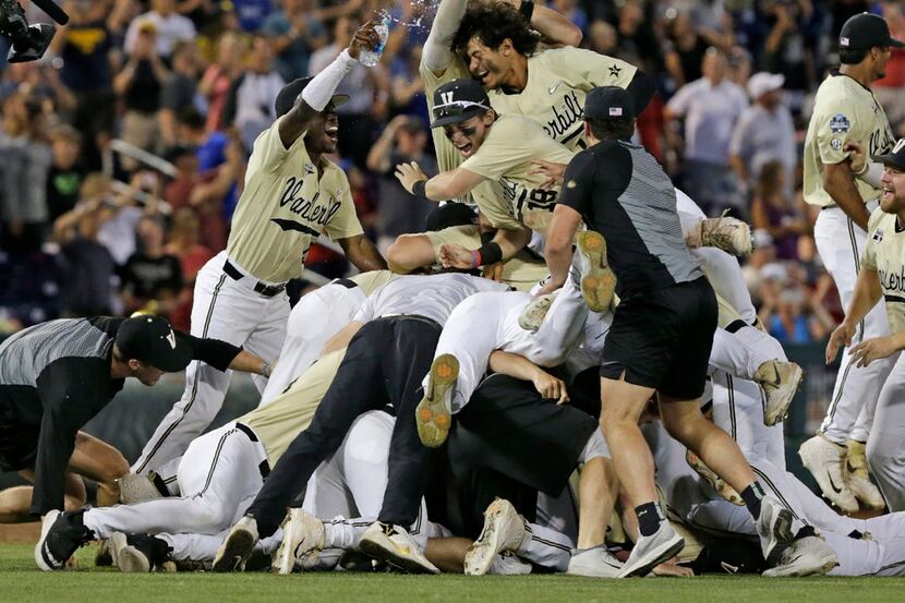 Vanderbilt players celebrate after defeating Michigan to win Game 3 of the NCAA College...