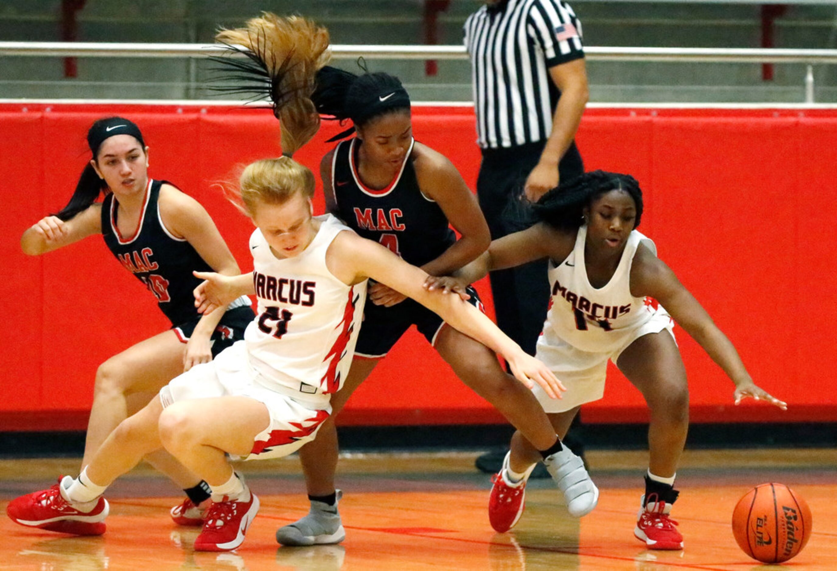 Irving MacArthur High School forward Morgan Browning (4) tries for a loose ball between...