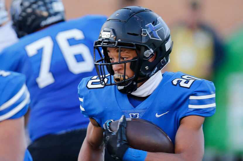 Hebron running back Isaiah Broadway looks for running room in a regional semifinal playoff...