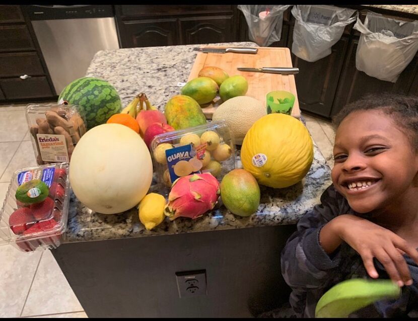 E'Syntheis Chambers, 7, is seen with fruits that make his business successful.