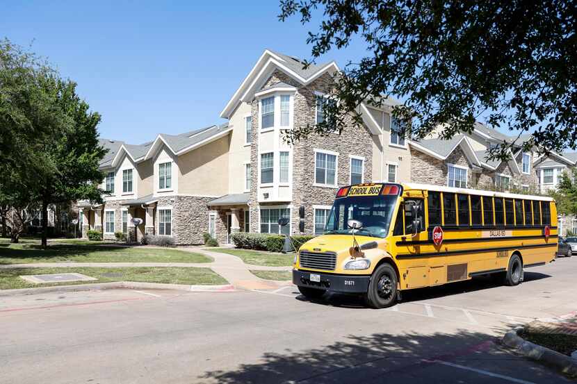A Dallas Independent School District bus drives down the 4100 block of Delafield Lane,...