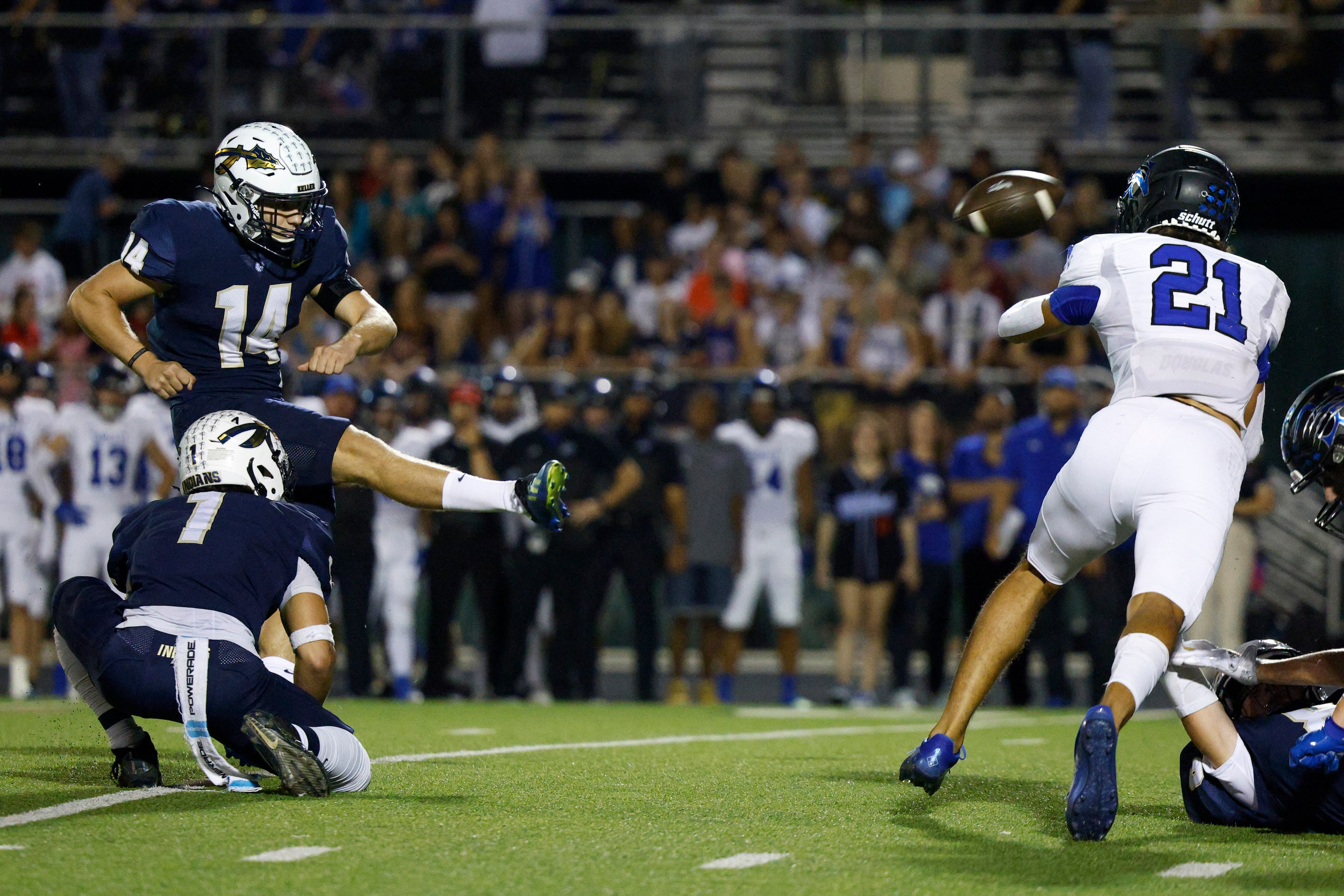 Keller kicker Garrett Martin (14) converts on a field goal attempt as Trophy Club Byron...