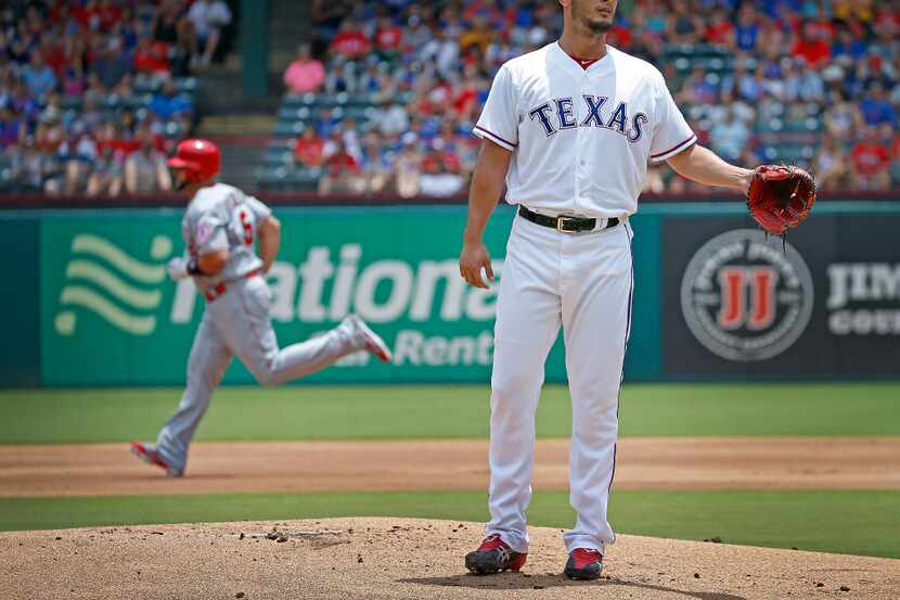 Texas Rangers starting pitcher Yu Darvish (11) stands on the mound after giving up a solo...