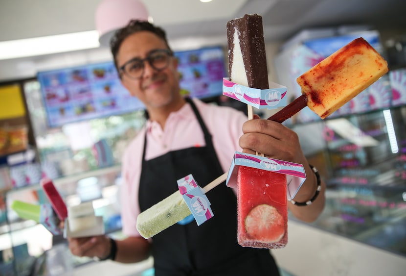 Owner Mario Cesar Ramirez poses for a photograph holding paletas at HA' Paletería in Plano.