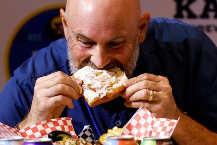 Brad Batson of Karbach Brewing Co. tastes the deep-fried BLT at the Big Tex Choice Awards in...