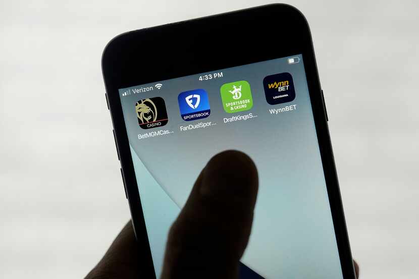 FanDuel, DraftKings and other online gambling apps are displayed on a phone in San...