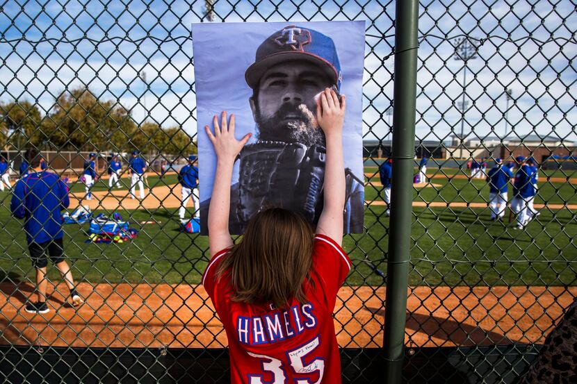 Texas Rangers fan Emily Field of Philadelphia, Pennsylvania hods up a photo of Texas Rangers...