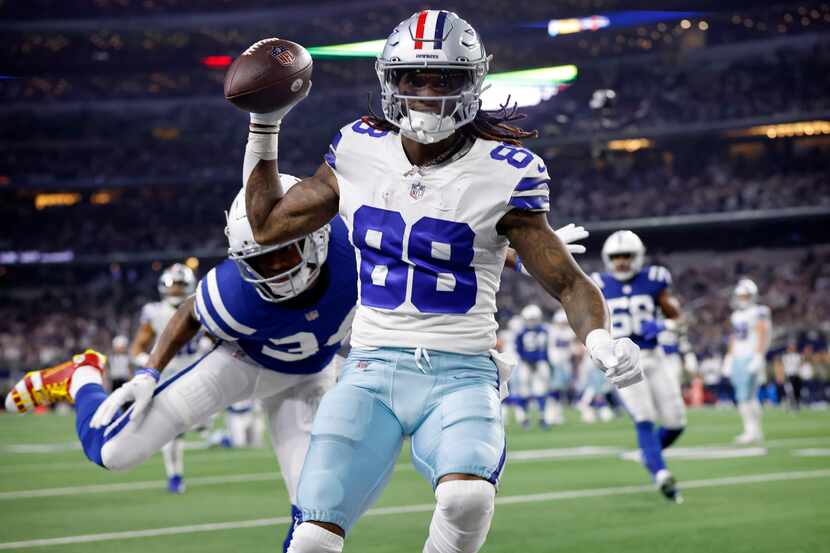 Dallas Cowboys wide receiver CeeDee Lamb (88) rolled off a defender and ran the ball in for...