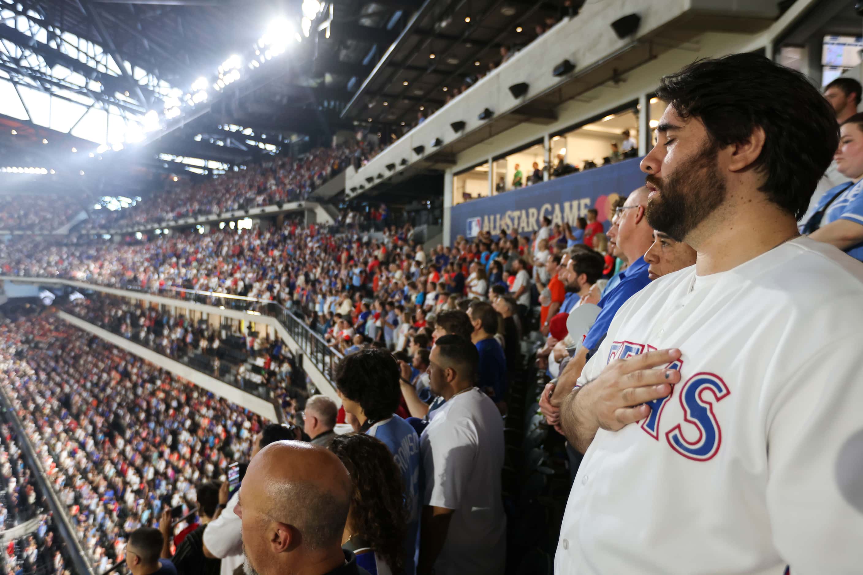 Crowd sing the National Anthem during MLB All-Star baseball game, on Tuesday, July 16, 2024,...