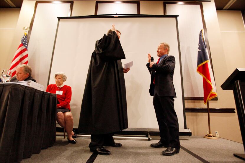 Judge David Schenck (left) swears in the newly elected chairman for the Dallas County...