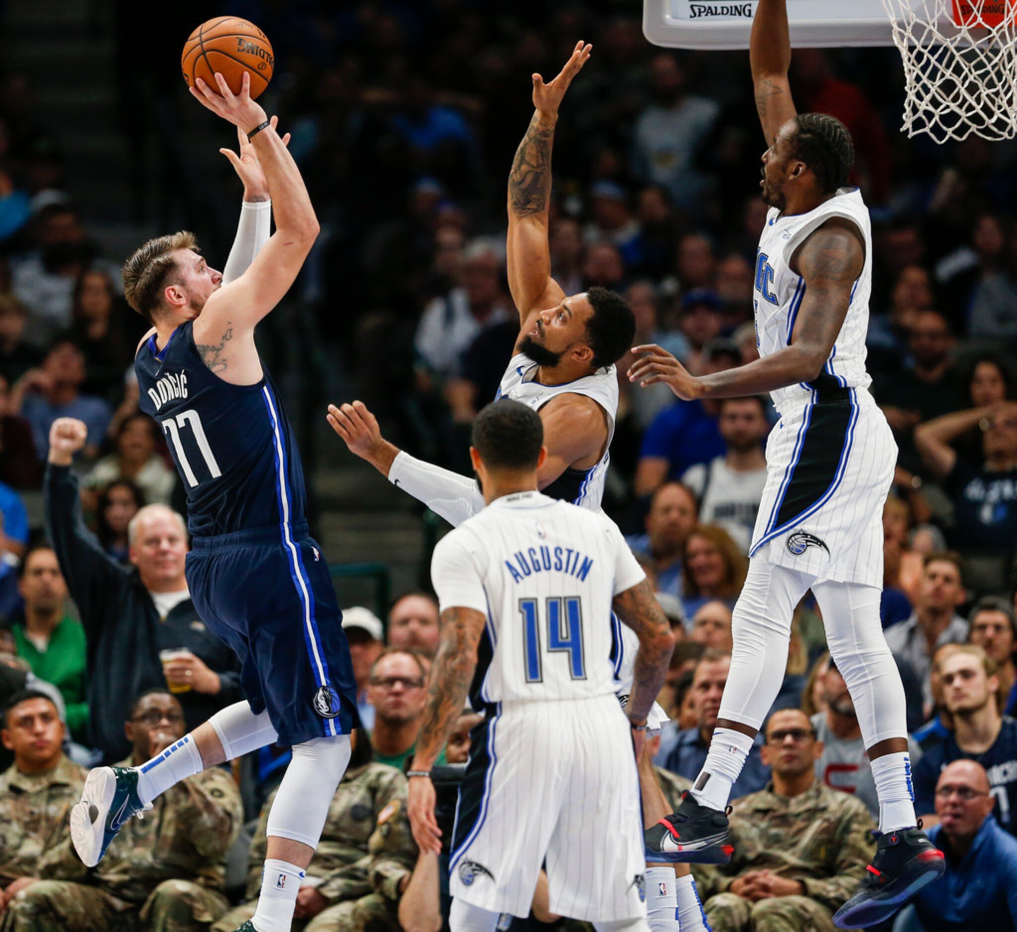 Dallas Mavericks guard Luka Doncic (77) goes up for a shot over Orlando Magic center Khem...